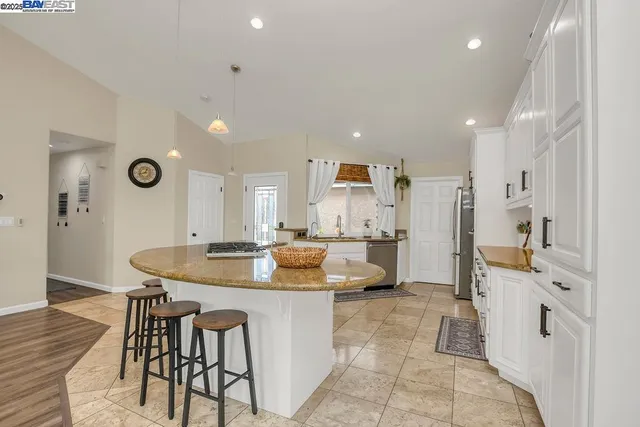 a large kitchen with a table and chairs