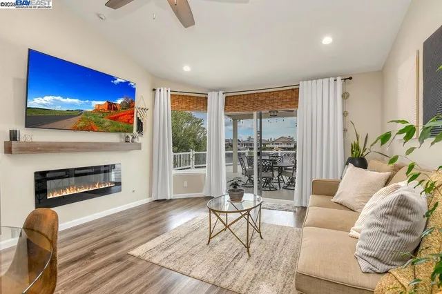 a living room with furniture a fireplace and a flat screen tv