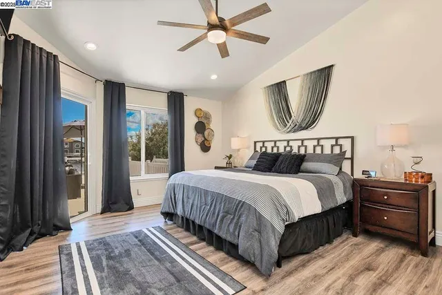 a bedroom with a large bed and a chandelier