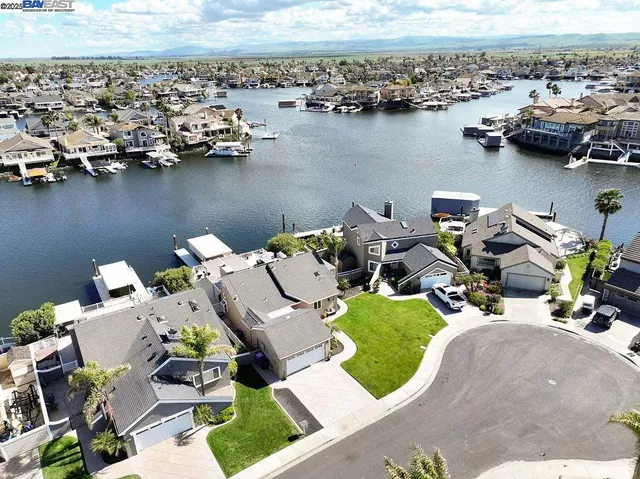 an aerial view of a house with outdoor seating