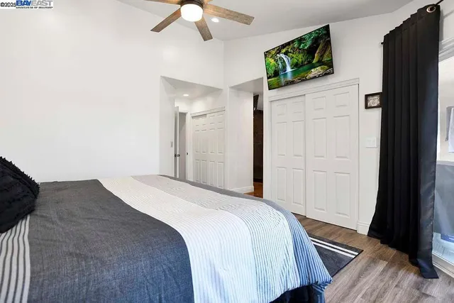 a bedroom with a bed and a flat tv screen