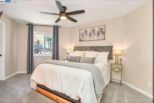 a bedroom with a bed and a painting on the wall