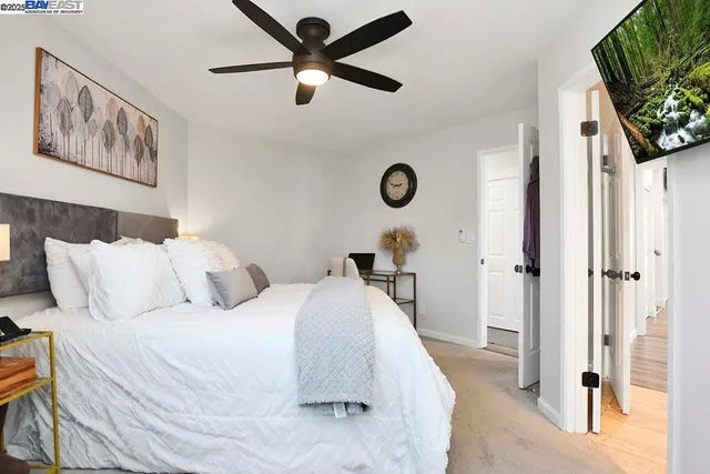 a bed room with a bed and a flat screen tv