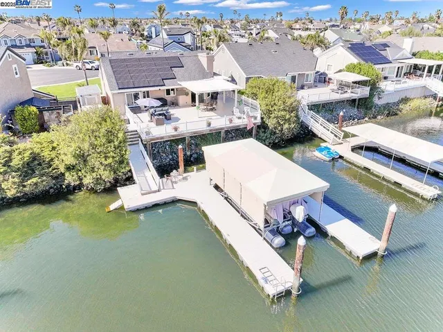 an aerial view of residential houses with outdoor space and swimming pool