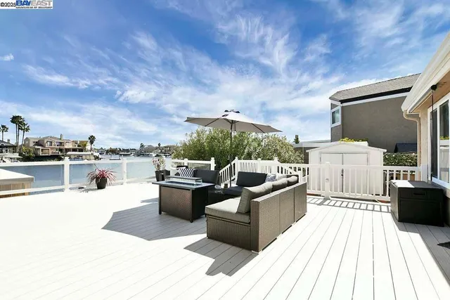 a view of roof deck with couches and sky view