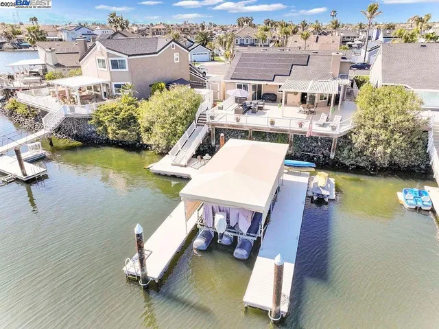 an aerial view of a house with swimming pool and ocean view