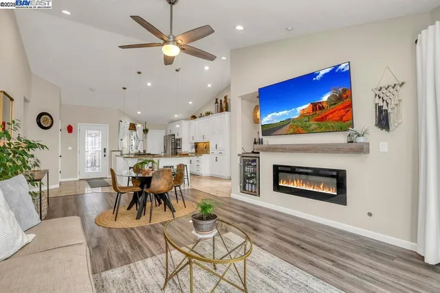 a living room with furniture a fireplace and a flat screen tv