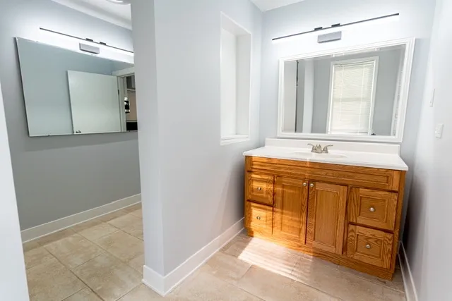 a bathroom with a sink vanity and mirror