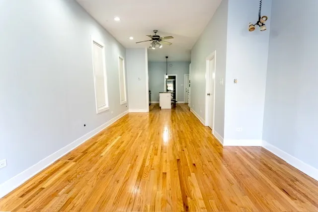 a view of a room with wooden floor
