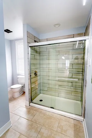 a bathroom with a shower and a bathtub