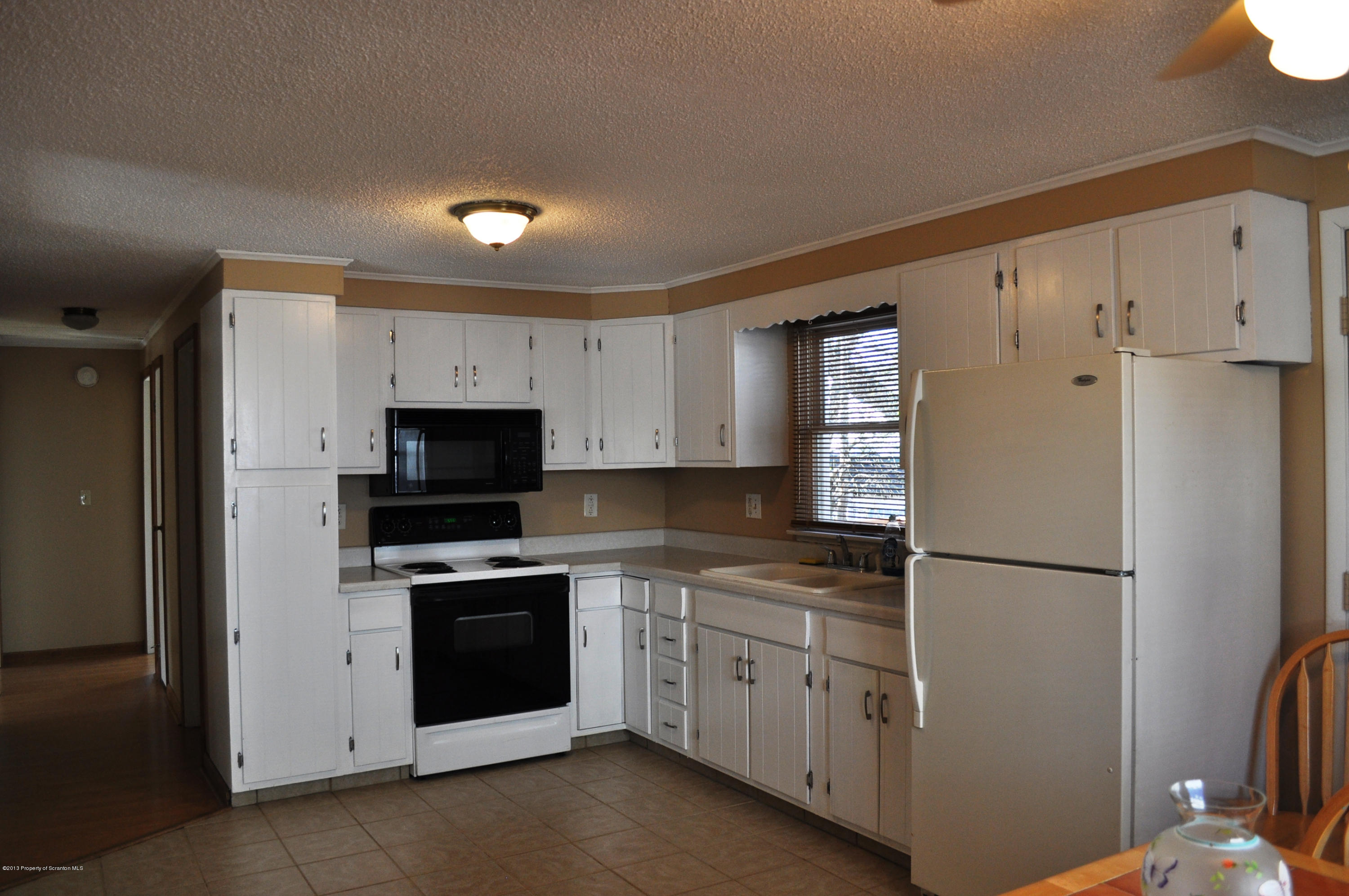 1817 Green Ridge Street Dunmore, PA 18509 - Photo 3 of 21 a kitchen with cabinets stainless steel appliances and a window