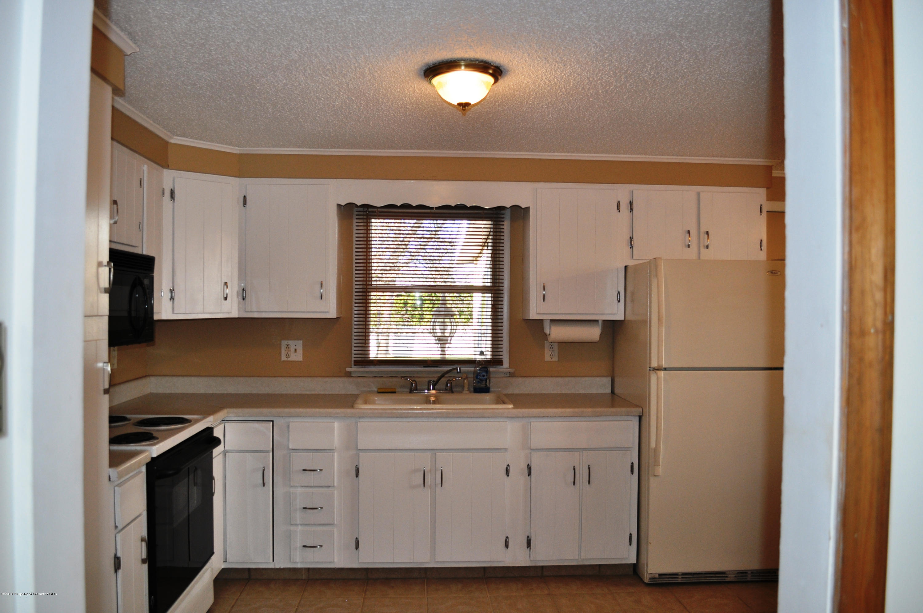 1817 Green Ridge Street Dunmore, PA 18509 - Photo 4 of 21 a kitchen with cabinets appliances a sink and a window