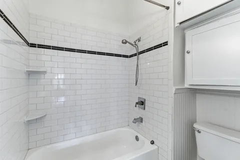 a bathroom with a tub and a shower