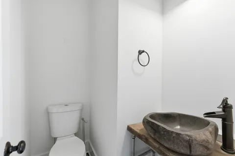 a view of a house with a large window and plants