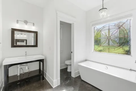 a front view of a house with yard and green space