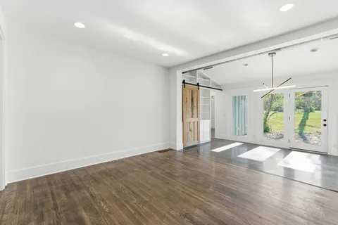 a view of a livingroom with wooden floor and a fireplace