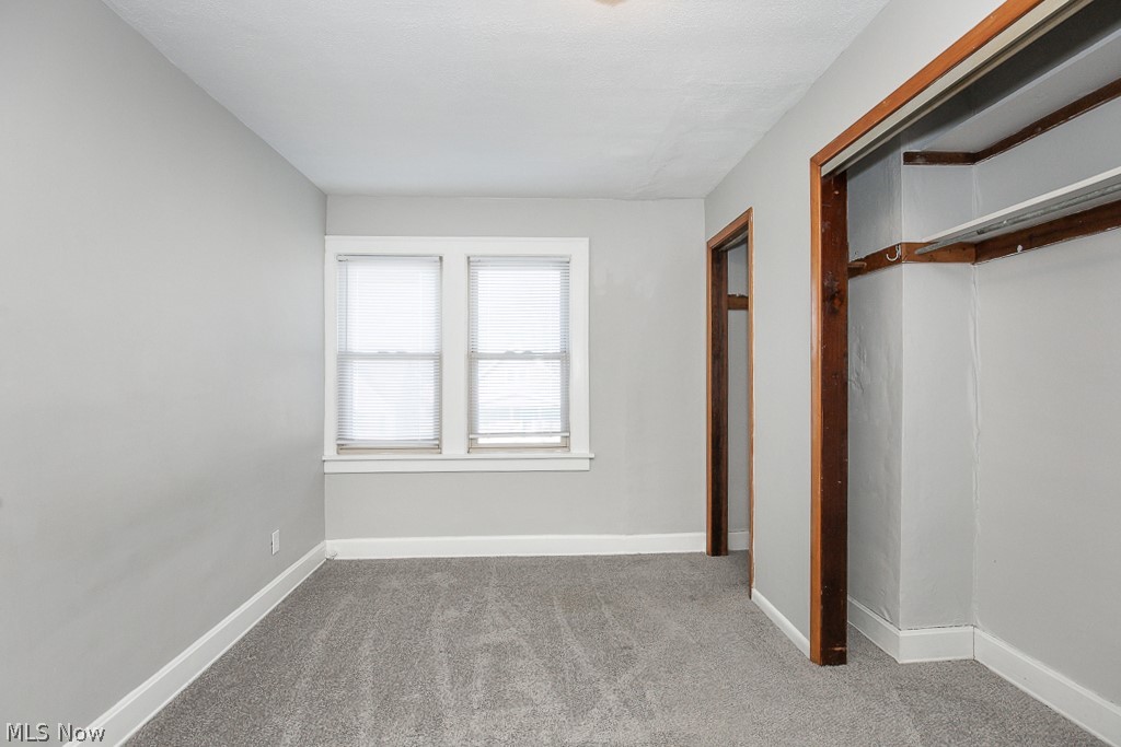 4661 Horton Road Cleveland, OH 44125 - Photo 14 of 27 Unfurnished bedroom with carpet flooring and a closet