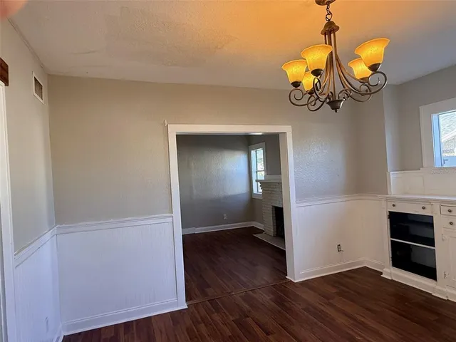 a view of a room with wooden floor