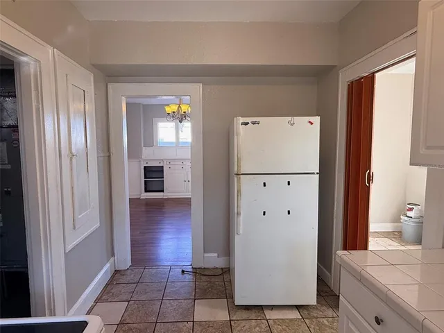 a view of a kitchen with a refrigerator cabinets and wooden floor