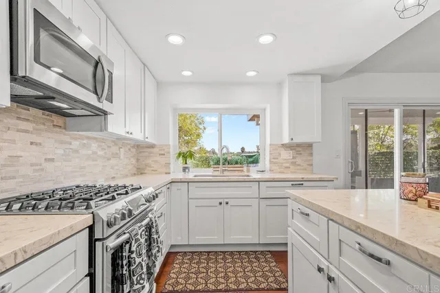 a kitchen with a sink stove and cabinets