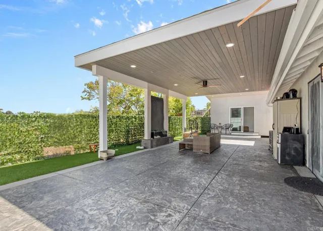 a view of a porch with furniture and garden