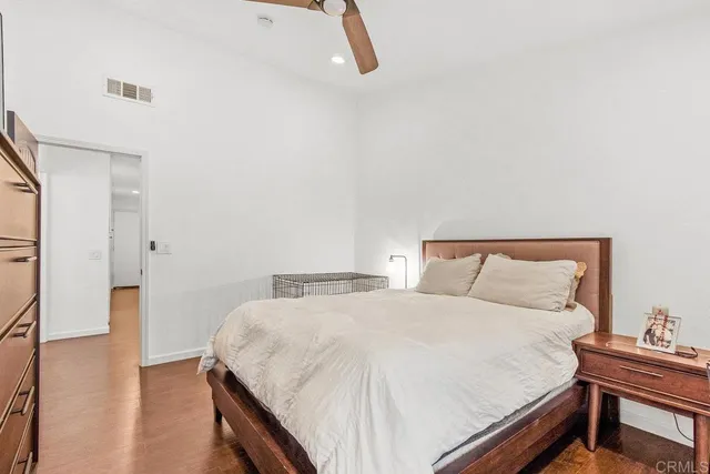 a bedroom with a bed and a night stand