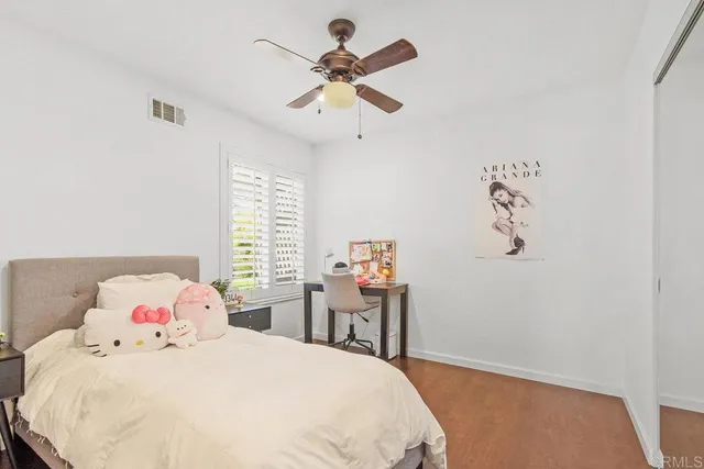 a bedroom with a bed and a window