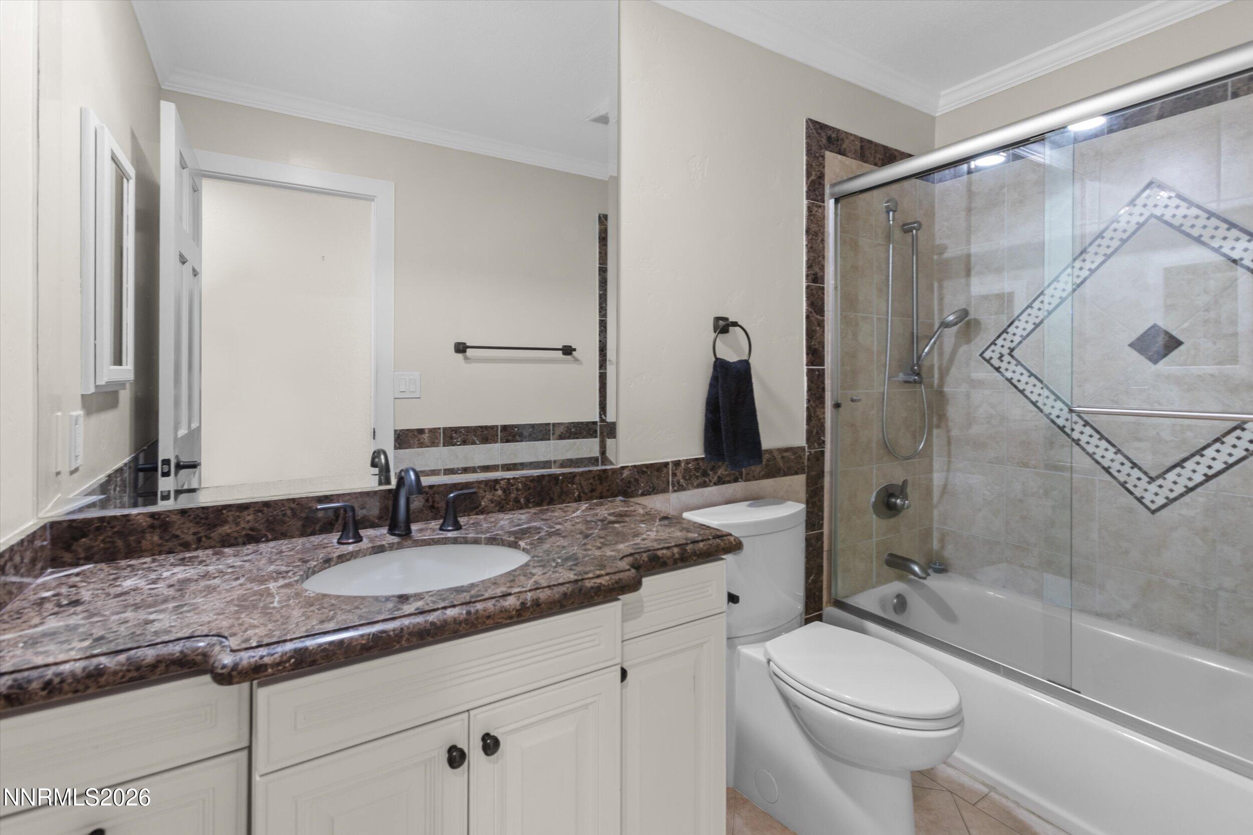 2725 West Lake Ridge Shores Reno, NV 89519 - Photo 27 of 49 a bathroom with a granite countertop sink toilet mirror and shower