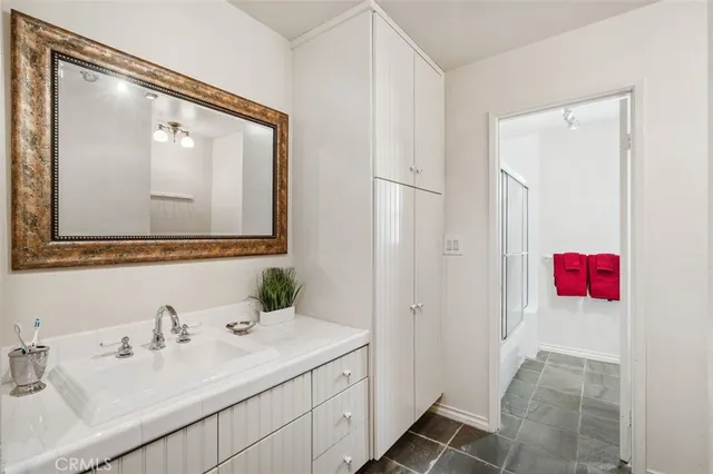 a bathroom with a sink vanity and a mirror