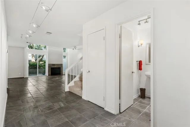 wooden floor in an empty room with a chandelier