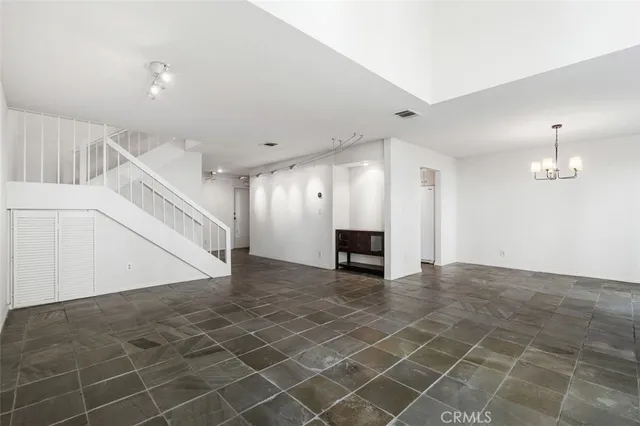 a kitchen with a sink dishwasher and white cabinets