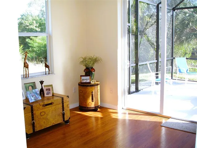 a view of a room with wooden floor and a window