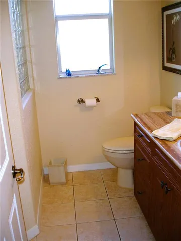 a bathroom with a toilet a sink and a mirror