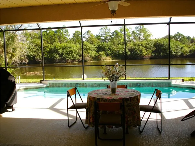 a view of swimming pool with a table and chairs