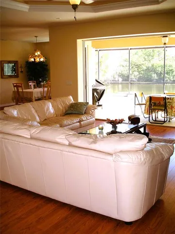 a room with wooden floor table and a large window