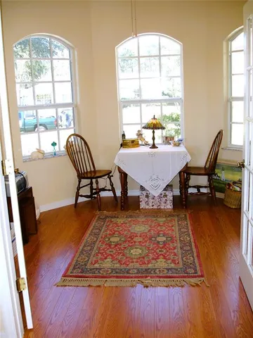 a living room with dining table and a wooden floor