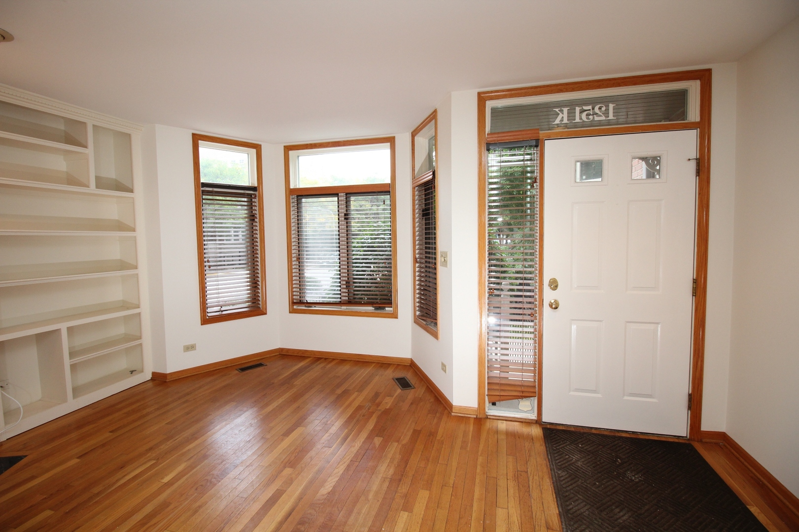 Undisclosed Address Chicago, IL 60657 - Photo 16 of 23 wooden floor in an empty room with a window