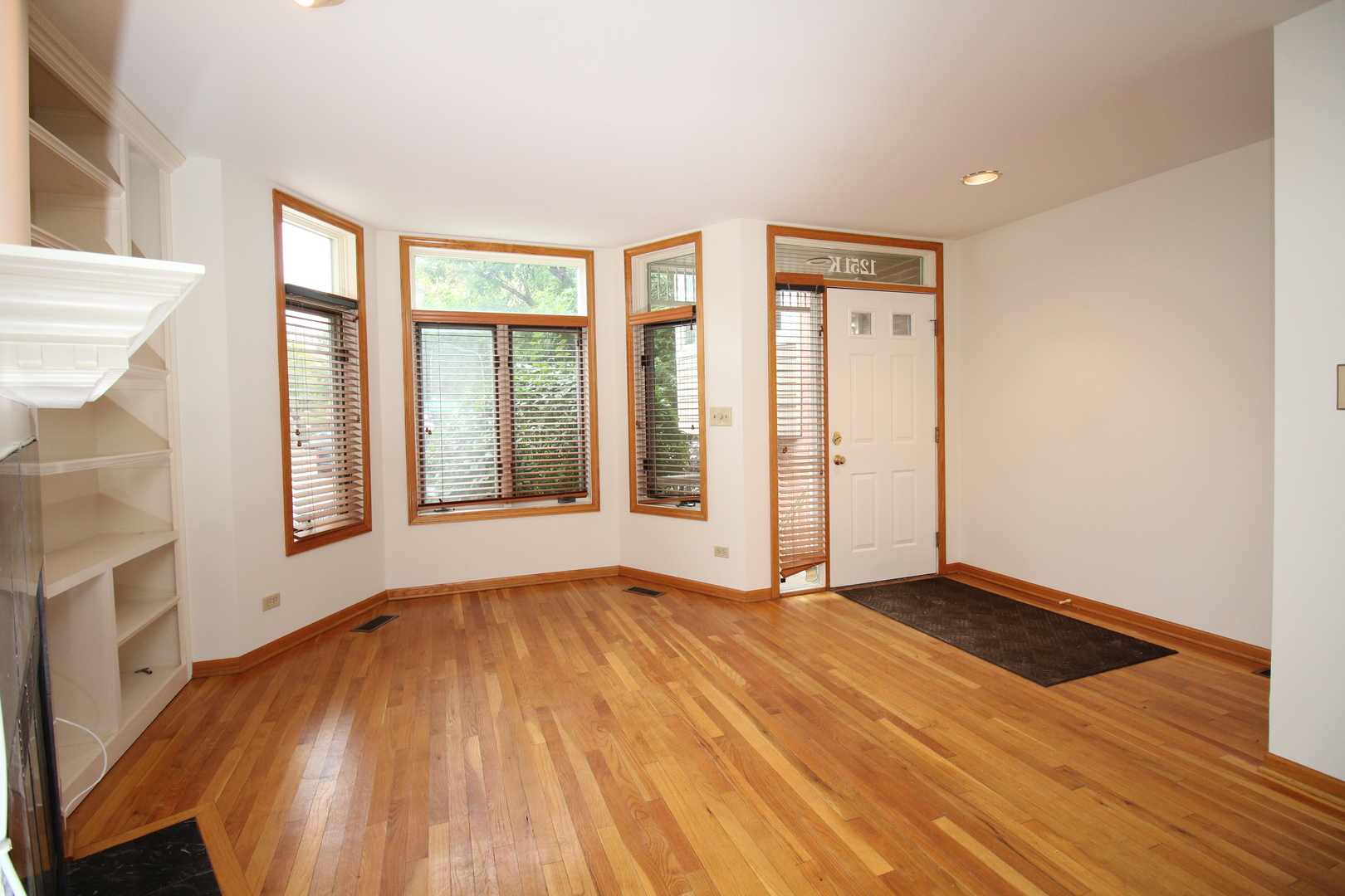 Undisclosed Address Chicago, IL 60657 - Photo 3 of 23 an empty room with wooden floor and windows