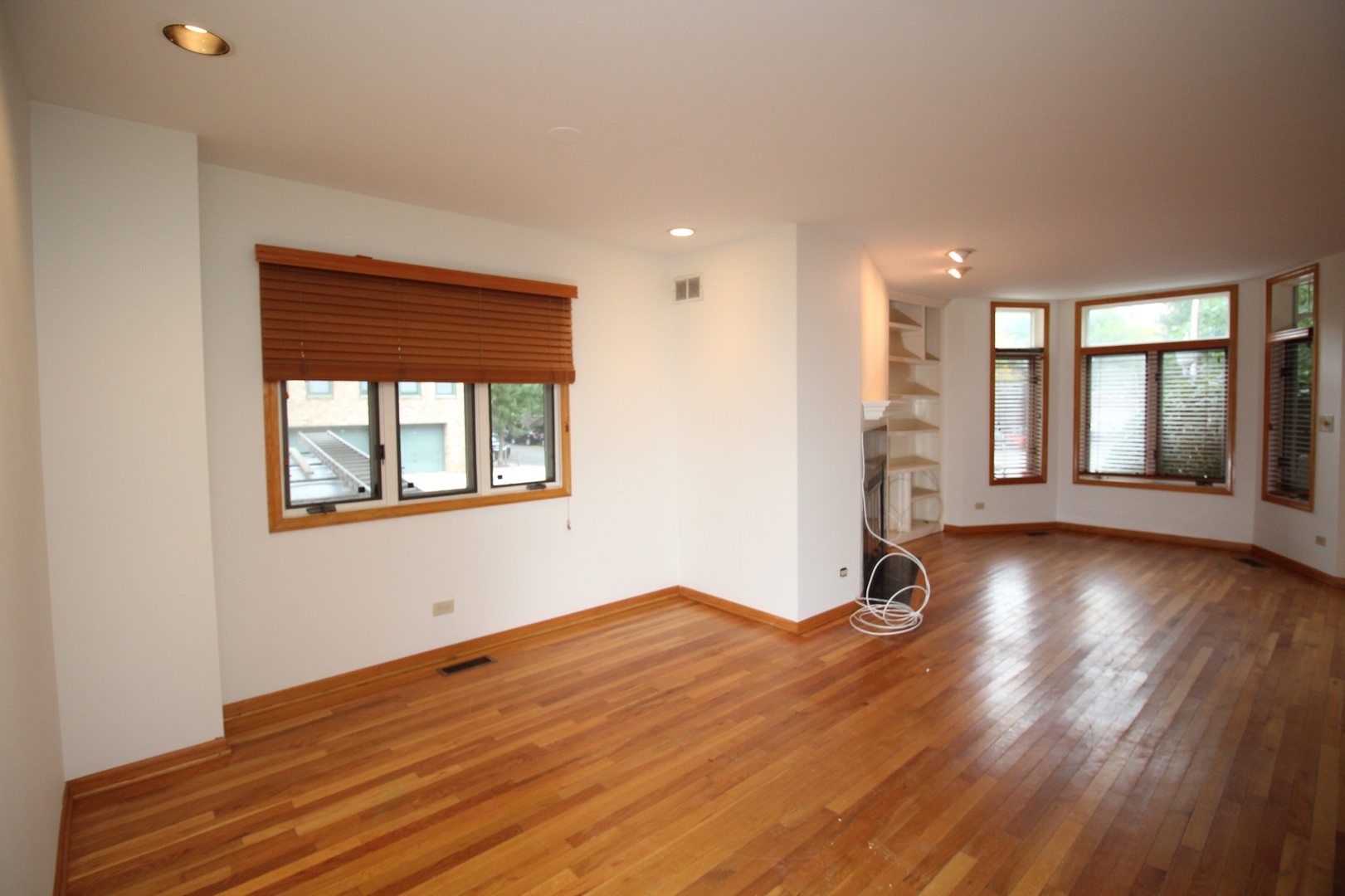 Undisclosed Address Chicago, IL 60657 - Photo 7 of 23 a view of livingroom with hardwood floor and window