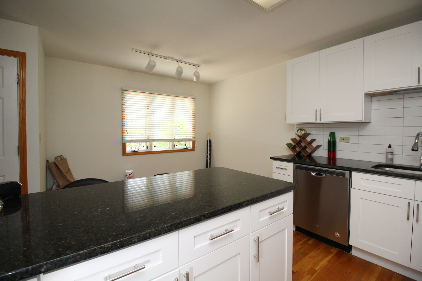 Undisclosed Address Chicago, IL 60657 - Photo 9 of 23 a kitchen with granite countertop a sink a stove and cabinets