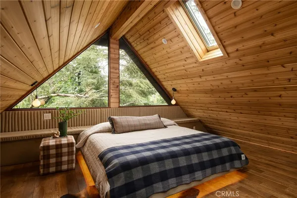 a bedroom with a bed and large window
