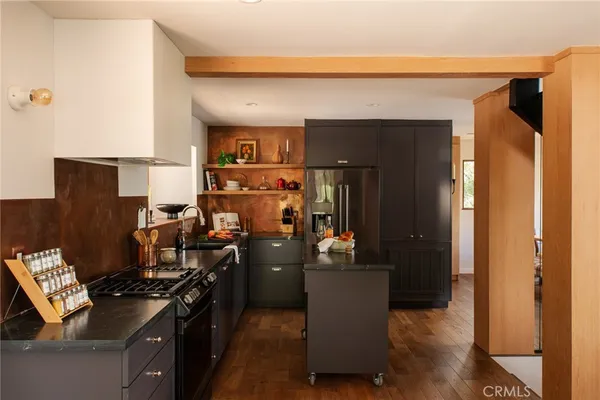 a kitchen with a refrigerator and a stove