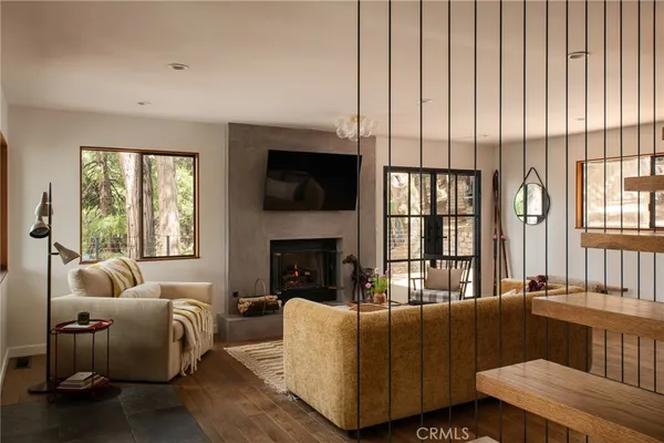 a living room with furniture fireplace and flat screen tv