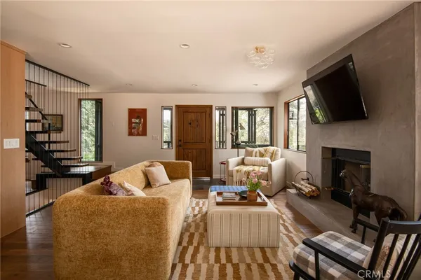 a living room with furniture fireplace and flat screen tv