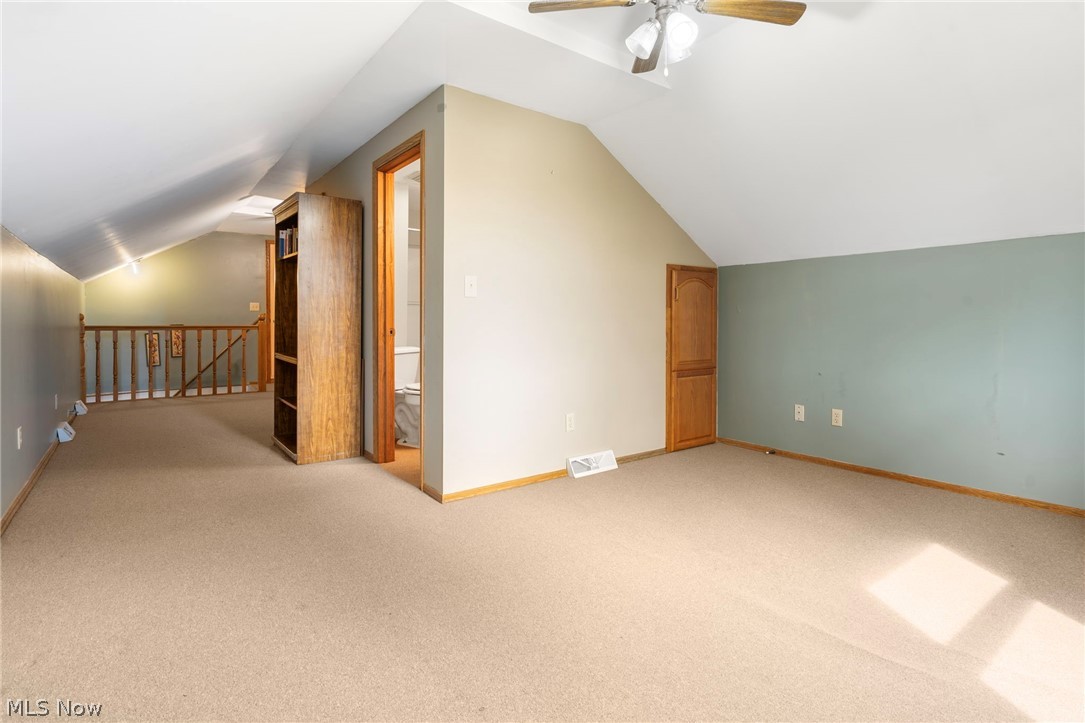 1850 South Sawburg Road Alliance, OH 44601 - Photo 23 of 39 Bedroom #3 on second floor with ceiling fan/light, lofted ceiling, and neutral carpet