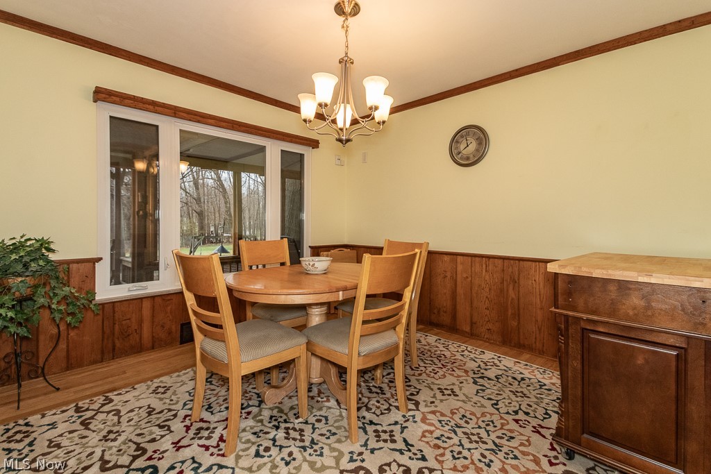 9771 Old Johnnycake Ridge Road Mentor, OH 44060 - Photo 13 of 29 Dining space with an inviting chandelier, crown molding, and light hardwood / wood-style flooring
