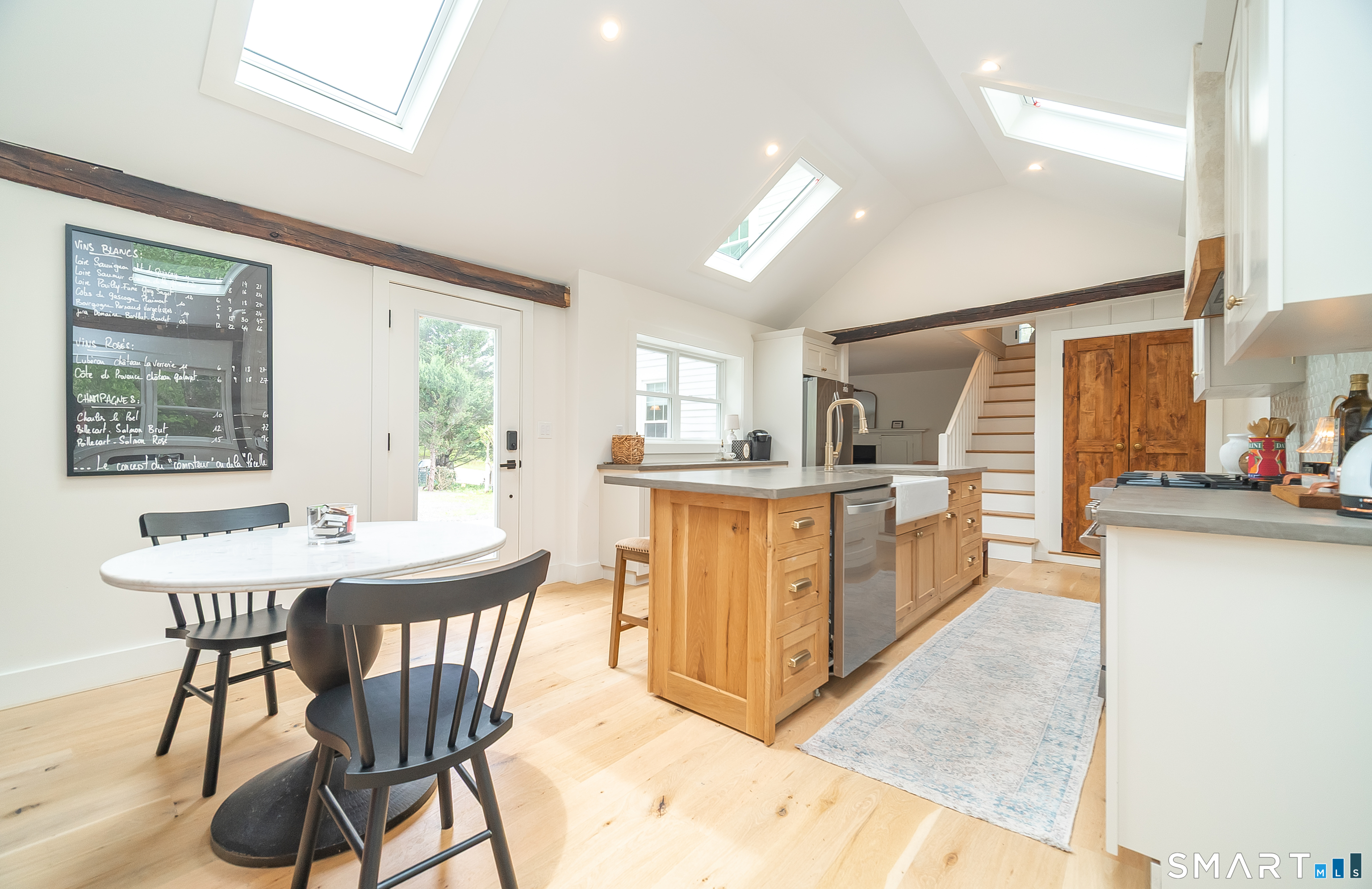 230 Killingworth Road Haddam, CT 06441 - Photo 7 of 36 a kitchen with stainless steel appliances kitchen island granite countertop a table chairs in it and a window