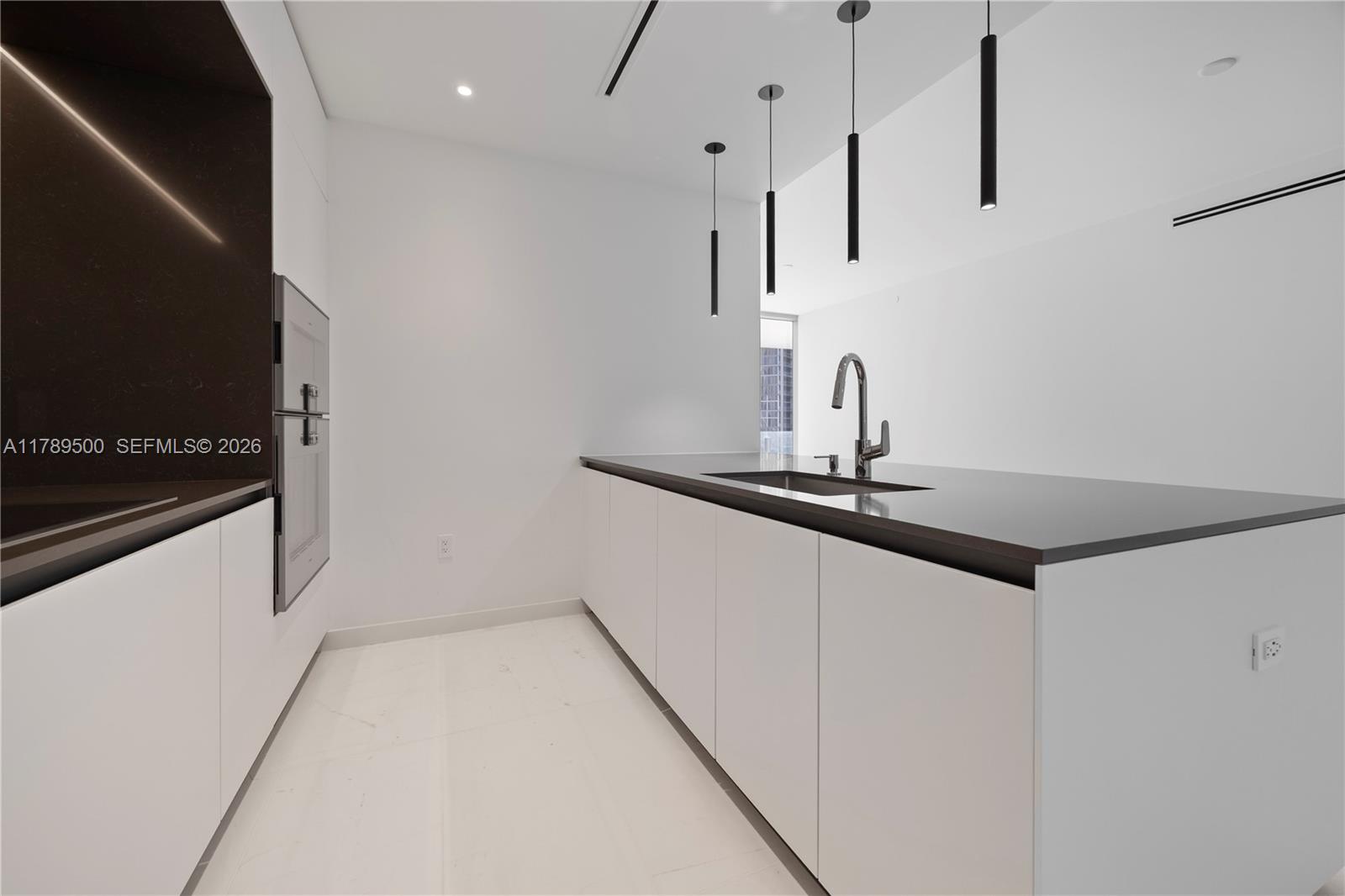 300 Biscayne Blvd Way, Unit 1102 Miami, FL 33131 - Photo 15 of 37 a kitchen with kitchen island a counter top space and appliances