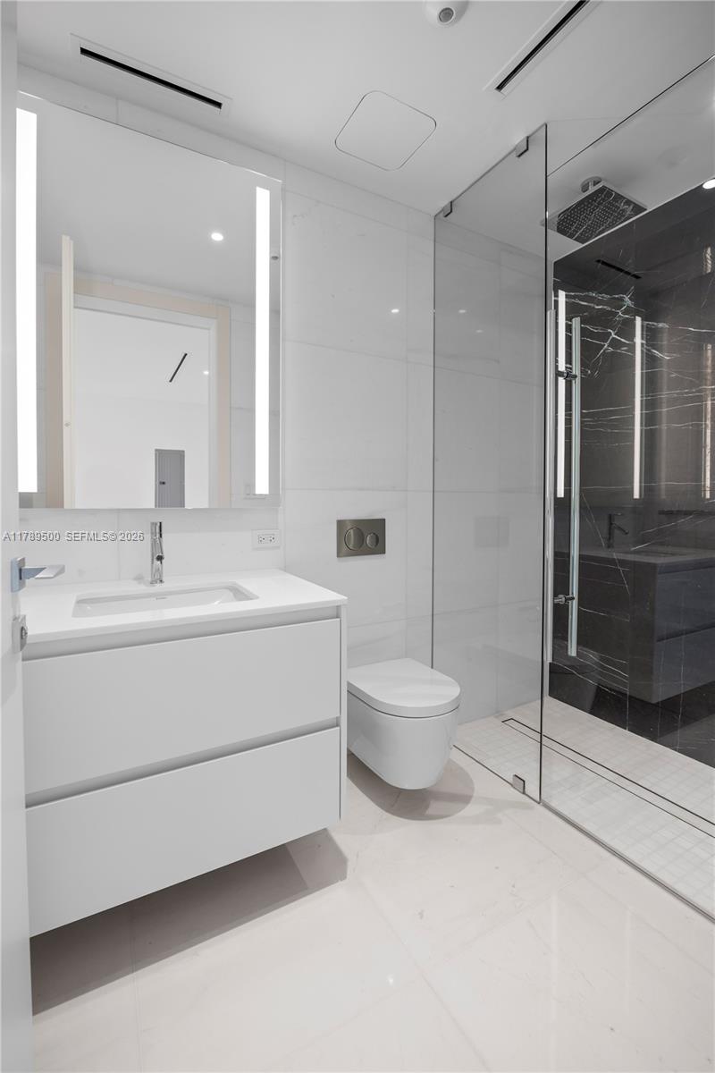 300 Biscayne Blvd Way, Unit 1102 Miami, FL 33131 - Photo 19 of 37 a bathroom with a sink a toilet and shower