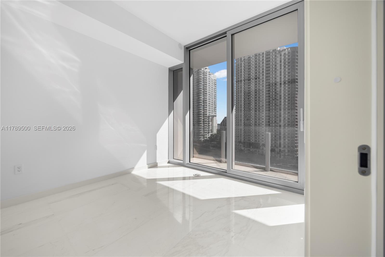 300 Biscayne Blvd Way, Unit 1102 Miami, FL 33131 - Photo 21 of 37 a view of an empty room with a window